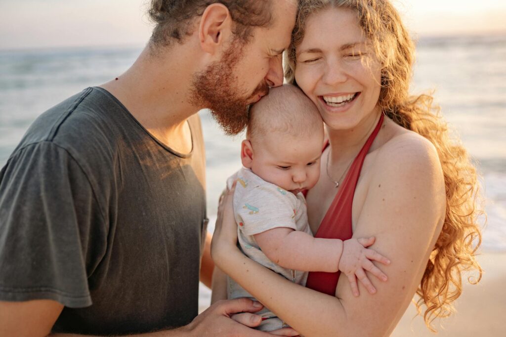 Family enjoying safe vacation at Moroccan beach with traditional architecture