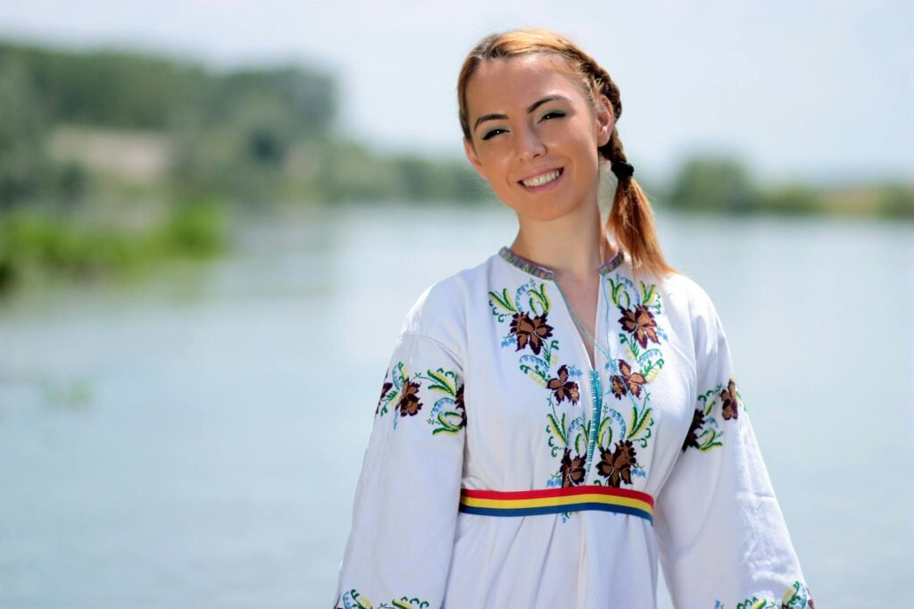 Tunisian woman wearing traditional Romanian blouse designed by Maria Zaibi