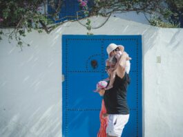 Tunisian family enjoying desert cuisine around a table with traditional dishes, including the Ksour cake