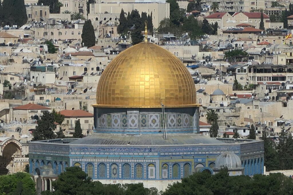 Turkish president speaking at a rally, with Al-Aqsa Mosque in the background