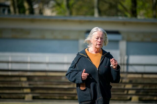 Gray Hair Healthy Lifestyle woman with healthy gray hair smiling at camera, symbolizing good health and cancer prevention