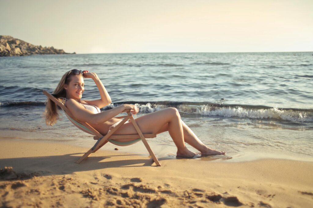 Woman enjoying thalassotherapy session on a Tunisian beach with golden sand and clear water