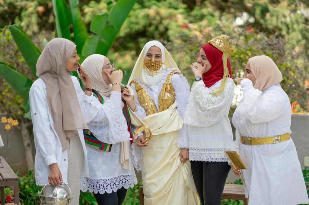 Women and children wearing stylish modest clothing at an Aid celebration in North Africa
