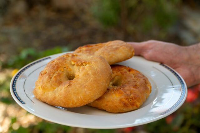 Authentic Makroud recipe featuring a plate of round cookies made with semolina and dates, prepared during Ramadan in a Morocc
