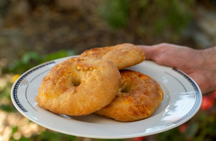 Authentic Makroud recipe featuring a plate of round cookies made with semolina and dates, prepared during Ramadan in a Morocc