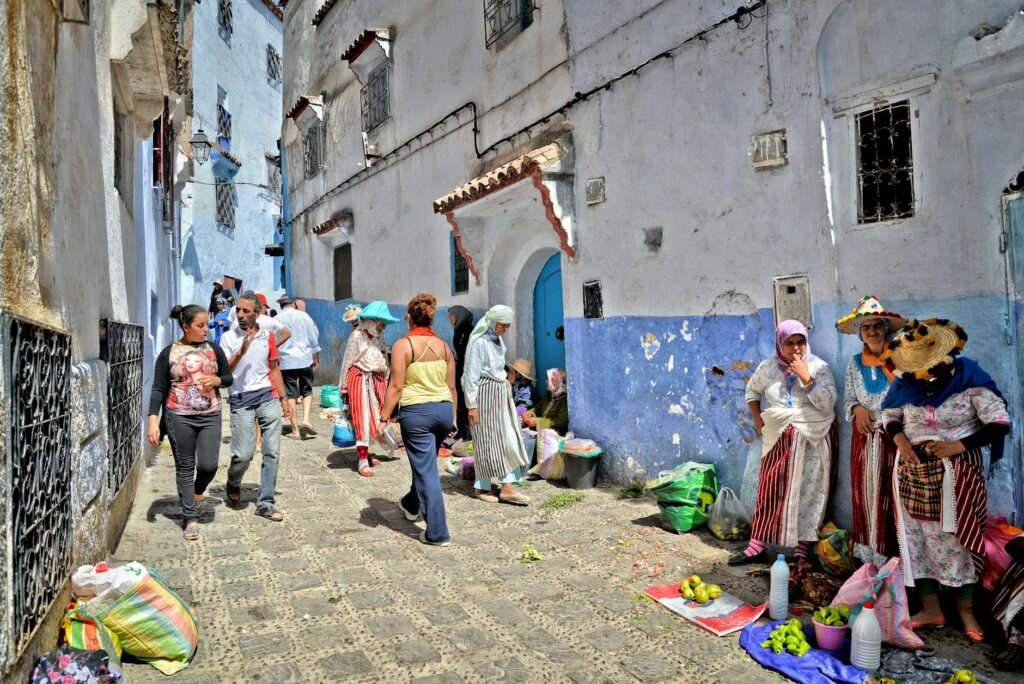 Women wearing traditional North African clothing at a market