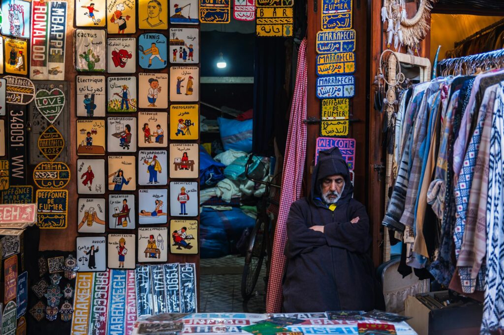 Woman using phone at Marrakech market, Morocco travel guide for diaspora members