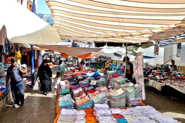 Woman shopping for traditional Moroccan goods at the Belmkaddem Festival of Heritage