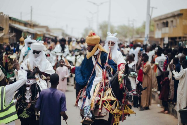 Muslims praying in a crowd during the festival while news of hostage crisis unfolds in Nigeria