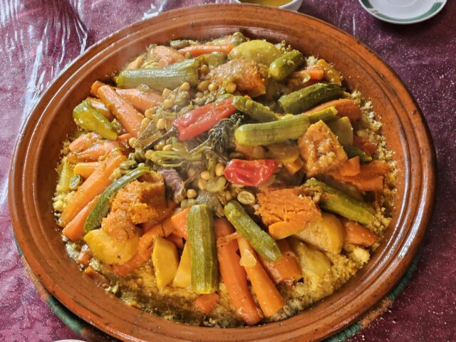 Family enjoying a plate of traditional Algerian couscous
