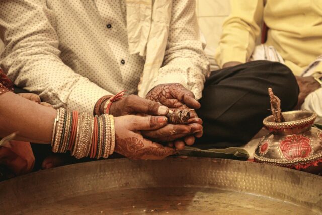 Hindu wedding ceremony in India with colorfully dressed bride and groom surrounded by family and friends
