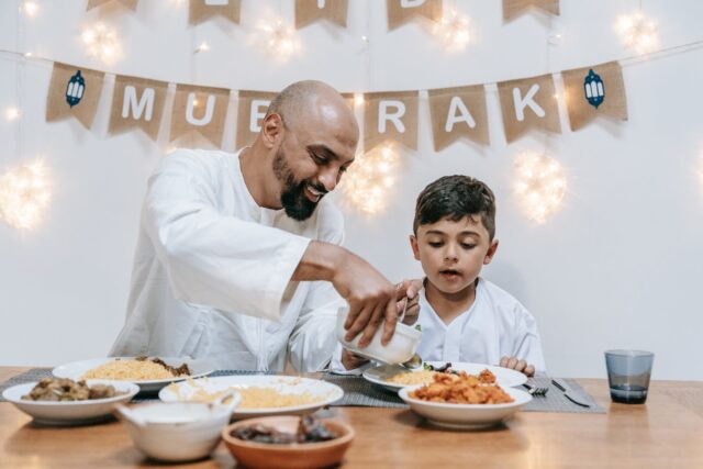 Family enjoying traditional Maghrebi dishes during Aid El-Fitr celebration