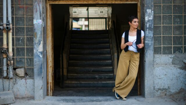 Maghrebin woman in contemporary outfit, blending traditional accessories and modern clothing