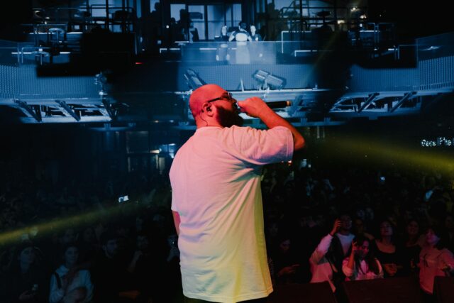 Young Maghrebin musicians performing rap music in a Parisian cityscape
