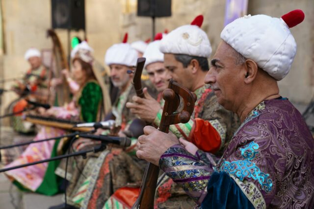 Moroccan musicians performing Kabareh Cheikhats, traditional instruments on stage