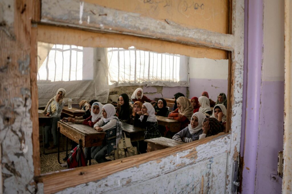 A diverse group of students in Villemur-sur-Tarn, France, attending a classroom in a historic rural setting