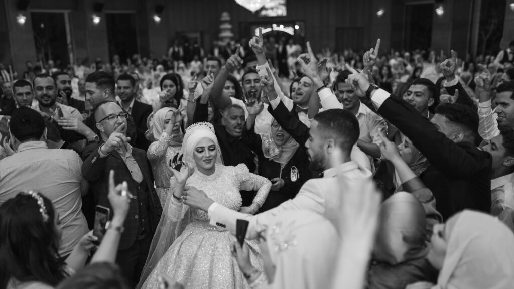 Couple married in traditional Maghreb wedding participating in Zaffa procession with musicians and dancers