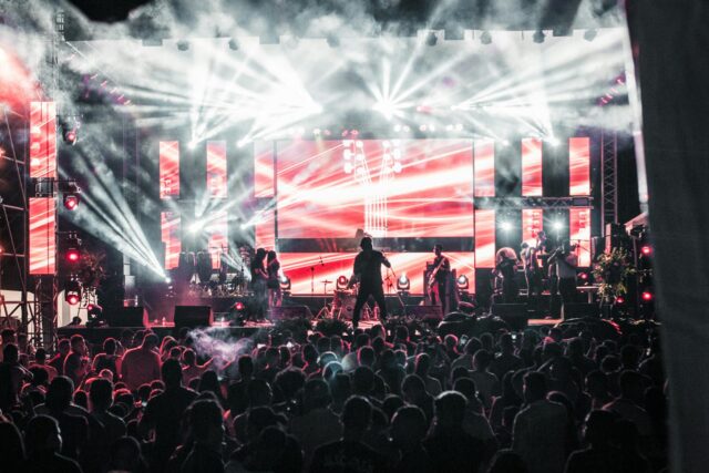Kendji Girac performing at a concert in the Middle East, surrounded by Arab fans