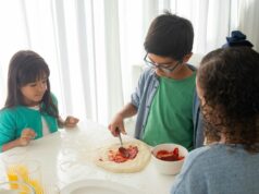 Recette traditionnelle des msemen : pas à pas vers la perfection Famille algérienne en train de préparer des msemen, délicieux plats crépés à base de farine et de beurre