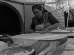 Tout ce que vous devez savoir sur les msemen : techniques et recettes woman preparing Tunisian Msemen with a rolling pin and ingredients on a countertop