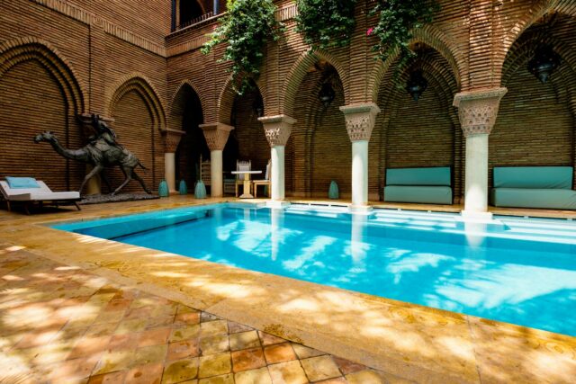 Moroccan luxury hotel stay Unforgettable Moroccan hotel stay with palm trees and pool