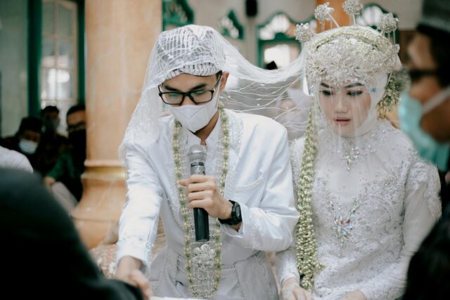 Traditional Maghrebi wedding ceremony with bride, groom, and guests in colorful cultural attire