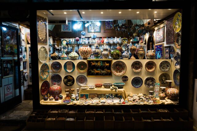 Cherbourg Marocain Craft Shop Interiors Moroccan artisan shop interior with colorful rugs, ceramics, and metalware on display