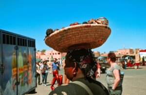 Le Maroc prend la première place du tourisme africain selon l’OCDE : une victoire pour notre pays! Vieille femme marocaine avec des vêtements traditionnels dans une souk à Marrakech