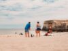 Les meilleures destinations de vacances en Algérie en été : découvrez les joyaux du pays Famille sur la plage en Algérie avec vue sur ruines historiques