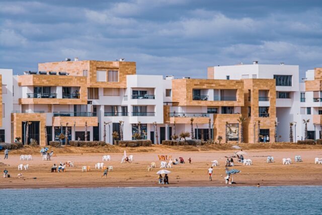 all-inclusive resort in morocco with palm trees, pool, and beach