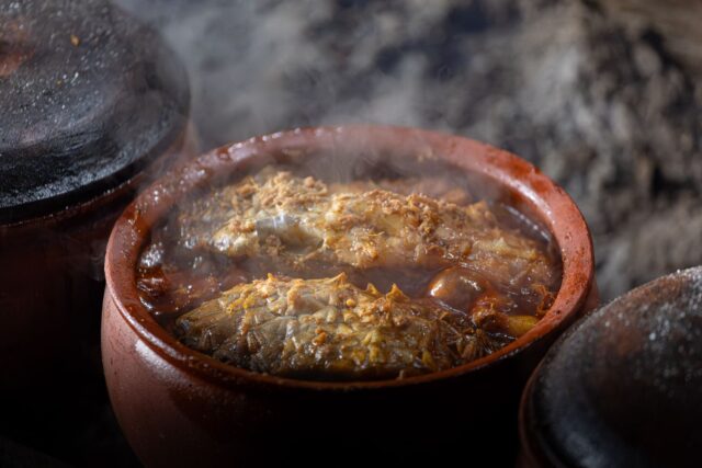 Family gathering around a table with authentic Chorba Frik dish