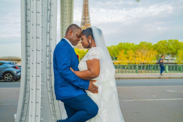 Traditional African wedding in Sussex followed by a memorable Paris party with a couple embracing in front of Eiffel Tower