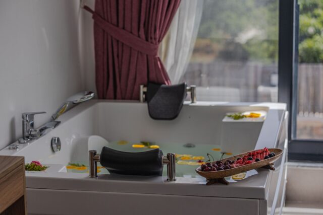 Woman enjoying a spa treatment in the idyllic setting of Massif Central's Mezenc Spa surrounded by majestic mountains and lus