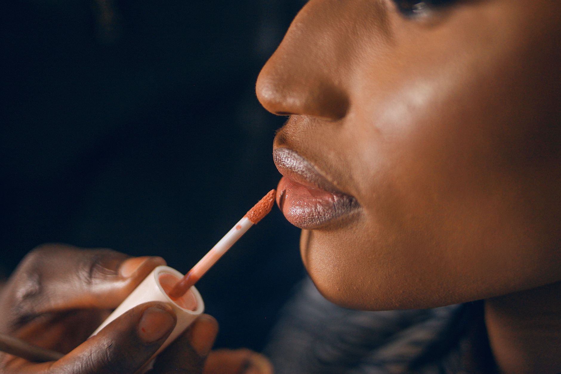 Imaan Hammam applying makeup in a modern Moroccan setting