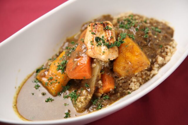 Moroccan sweet potato stew dish Moroccan sweet potato and chicken stew served with fresh herbs and spices