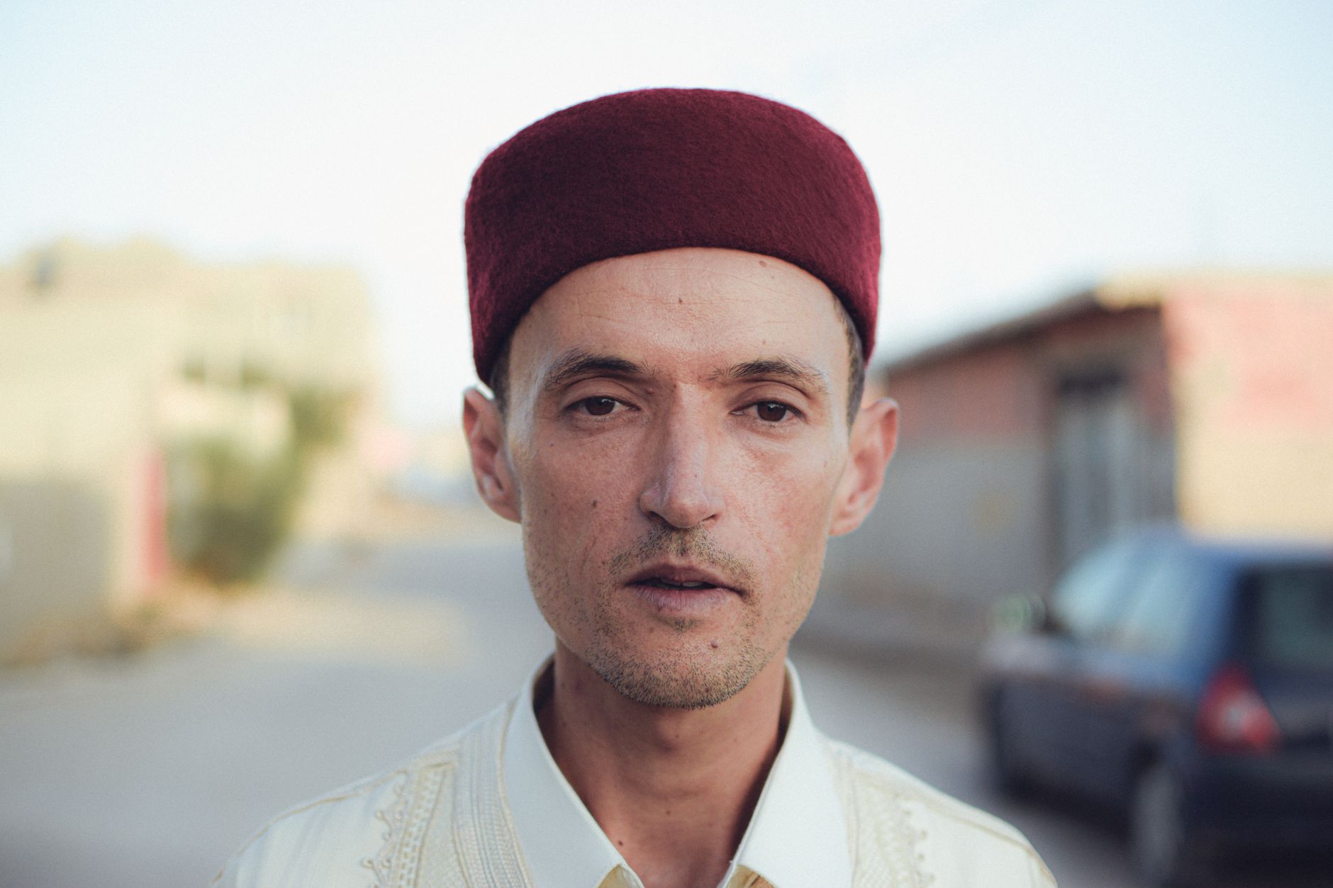 Taoufik Behi performing in a Tunisian venue, surrounded by a captivated audience
