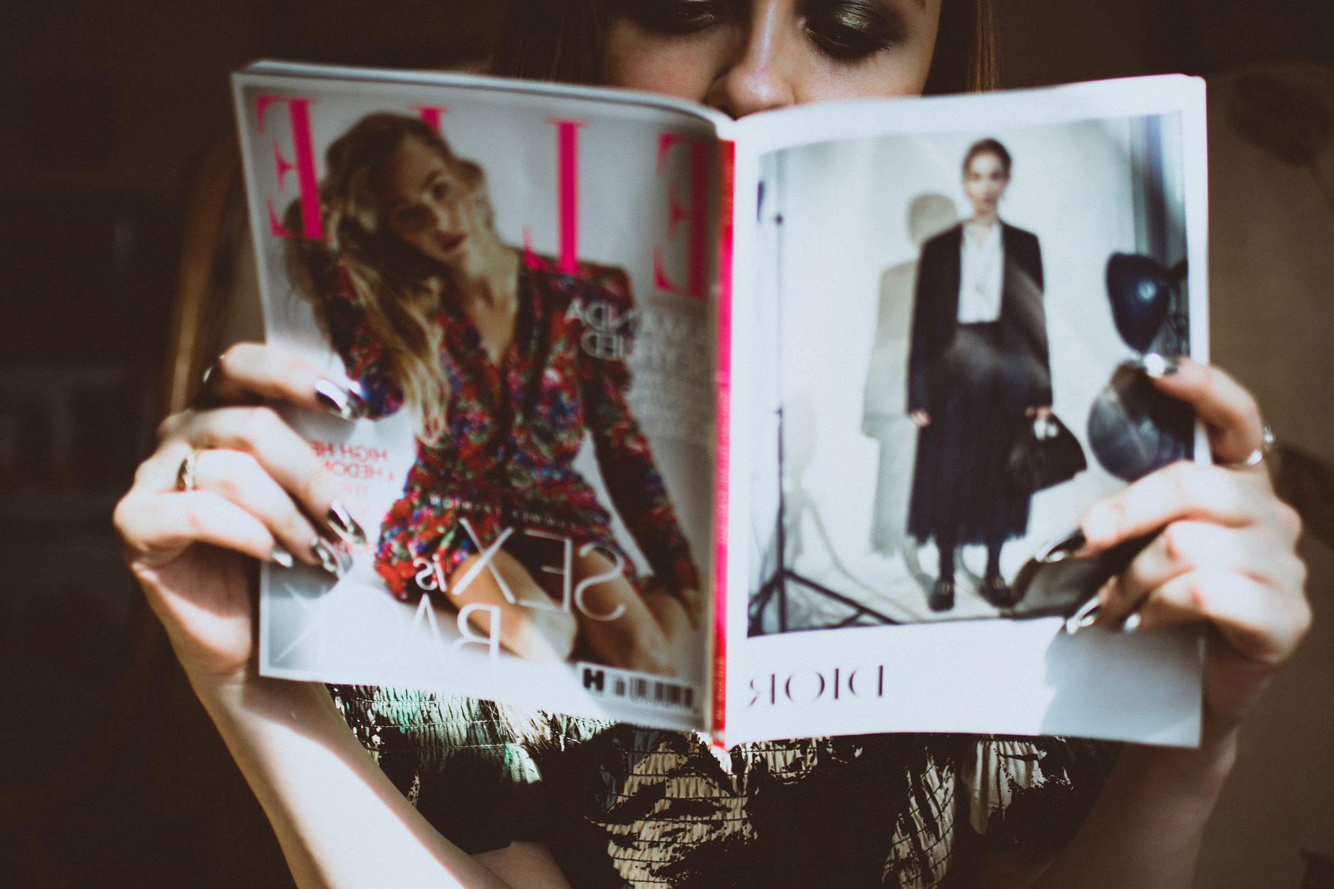 Woman reading Elle Marocaine magazine at a trendy cafe in Marrakech